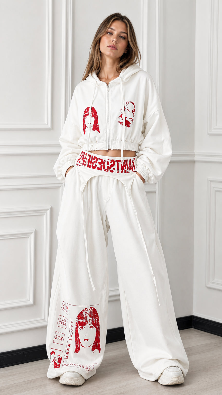 Front full view of woman wearing white cropped zip hoodie and matching wide leg graphic sweatpants