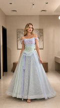 Model wearing pastel ombre glitter tulle ball gown with off-the-shoulder straps and floral bodice, front view