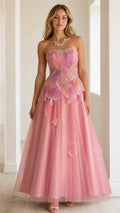 Front full view of woman wearing strapless blush pink beaded petal bodice tulle evening gown