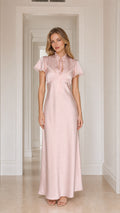 Model wearing pink satin lace-trim maxi dress, front view