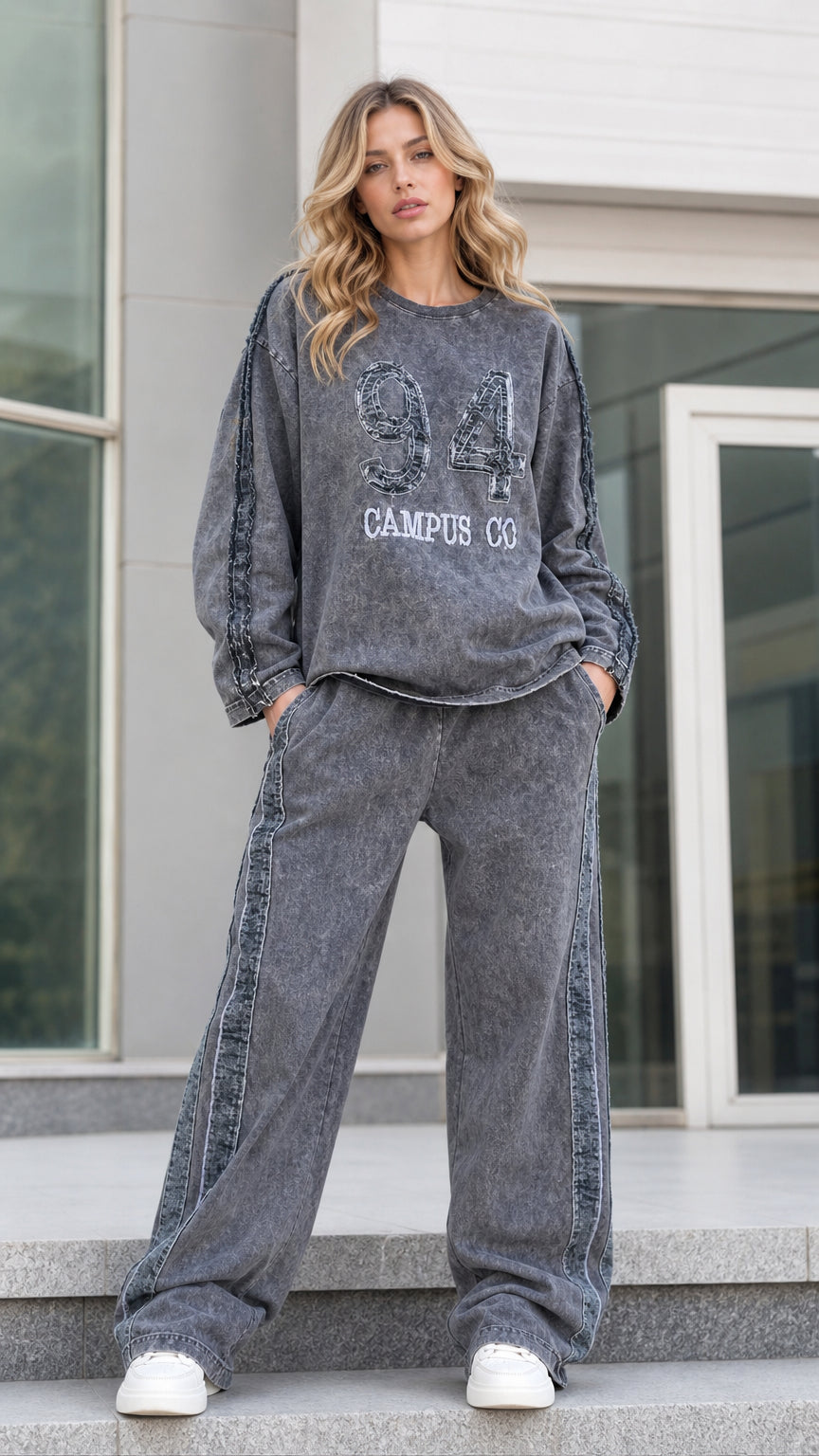 Front full view of woman wearing charcoal grey acid washed graphic sweatshirt and wide leg pants set