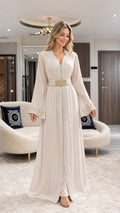Full front view of champagne pleated Moroccan caftan dress with jeweled belt
