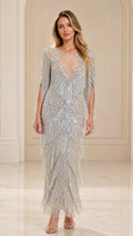 Front view of woman wearing silver sequin beaded fringe maxi gown with illusion neckline