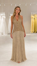 Front view of model wearing the Gold sequin beaded fringe halter maxi dress