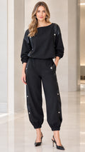 Full front view of women's black boat neck top and snap button jogger set