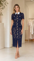 Full front view of model wearing Navy floral lace midi dress with contrast white collar and gold buttons