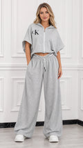Full front view of model wearing heather grey short sleeve cropped zip hoodie and wide leg lounge pants