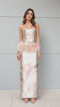 Full front view of champagne strapless jacquard corset maxi dress with feather hip trim