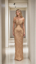 Front view of Champagne Gold off-the-shoulder beaded column evening gown with fringe details