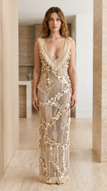 Front view of model wearing champagne sequin mesh maxi dress