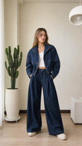 Full front view of model wearing dark blue cropped denim jacket and wide-leg matching pants set
