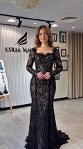 Full-length front view of black long sleeve lace mermaid evening gown