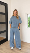 Model wearing Washed Blue oversized t-shirt and wide-leg pleated pants matching two-piece set front view