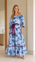 Front view of model wearing Light Blue off-the-shoulder floral stripe tiered maxi dress with burgundy belt