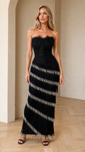 Front view of model wearing black strapless lace corset maxi dress with beaded fringe