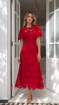 Front full view of woman wearing vibrant red floral embroidered lace A-line midi dress
