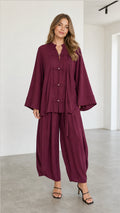 Front full view of women's burgundy Zen style tunic top and matching lantern pants set
