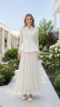 Front view of white pearl-embellished peplum top and lace maxi skirt set