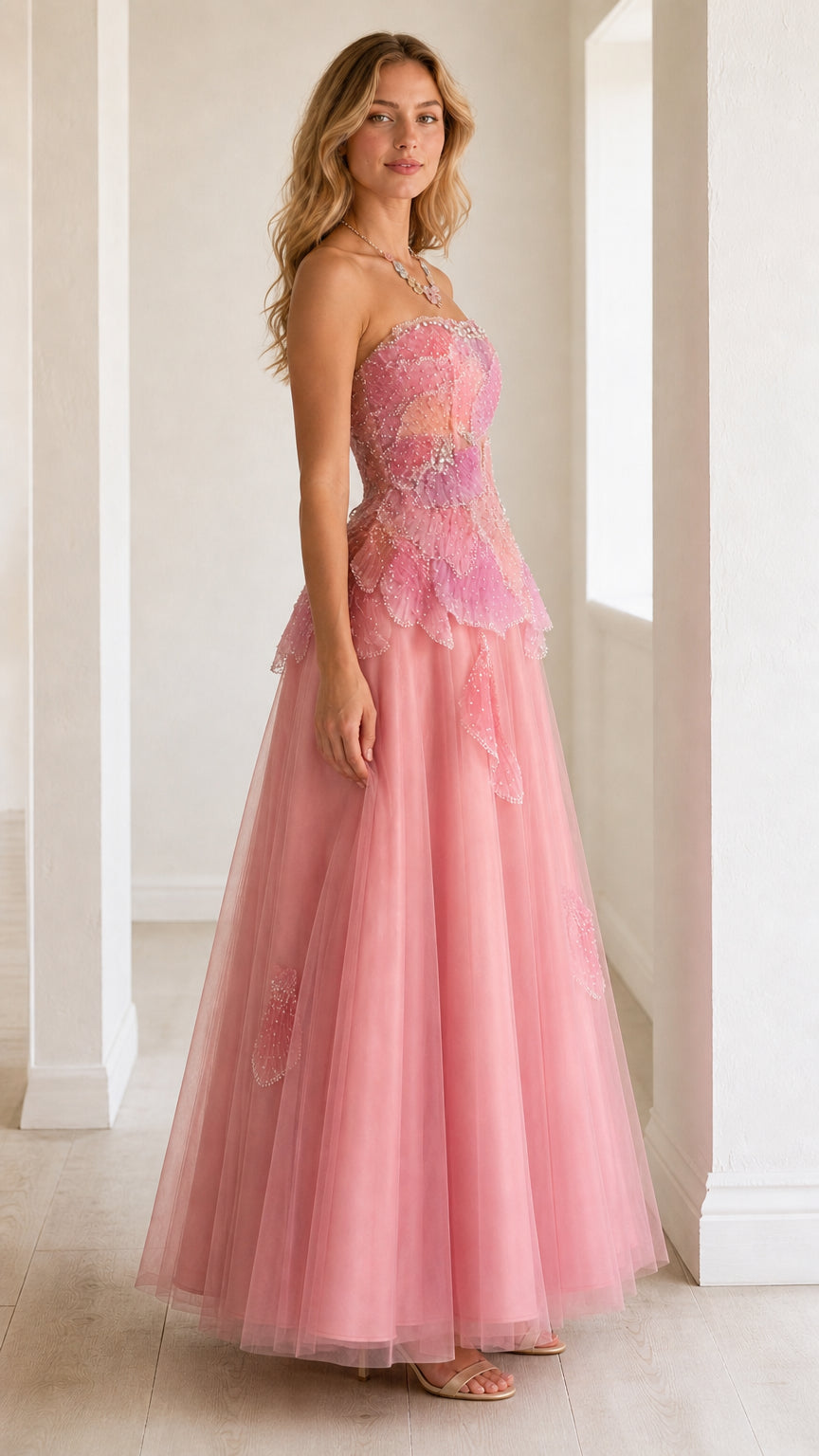 Side profile view of strapless blush pink tulle ball gown