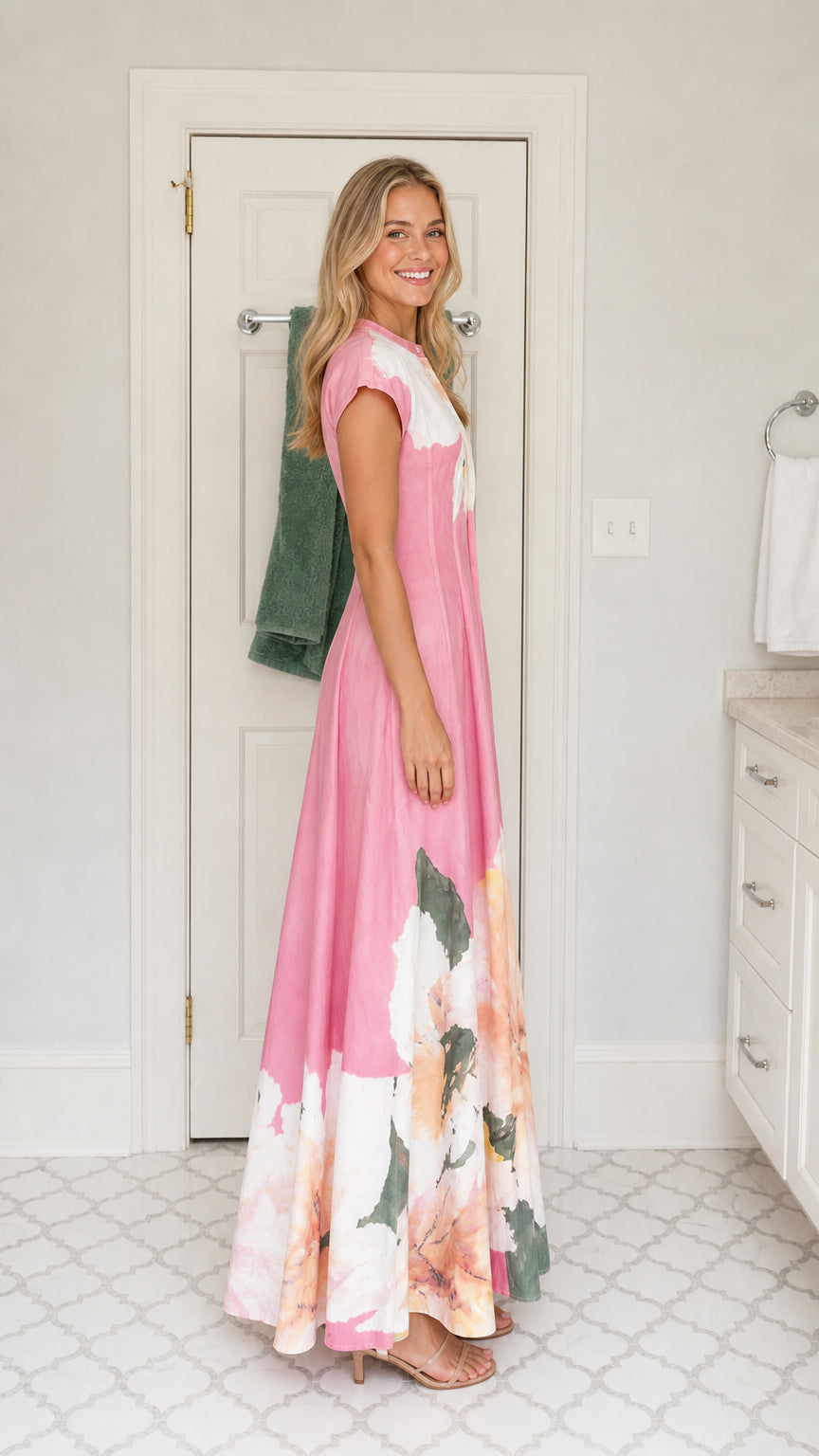 Side profile view of woman wearing pink floral cap sleeve A-line maxi dress
