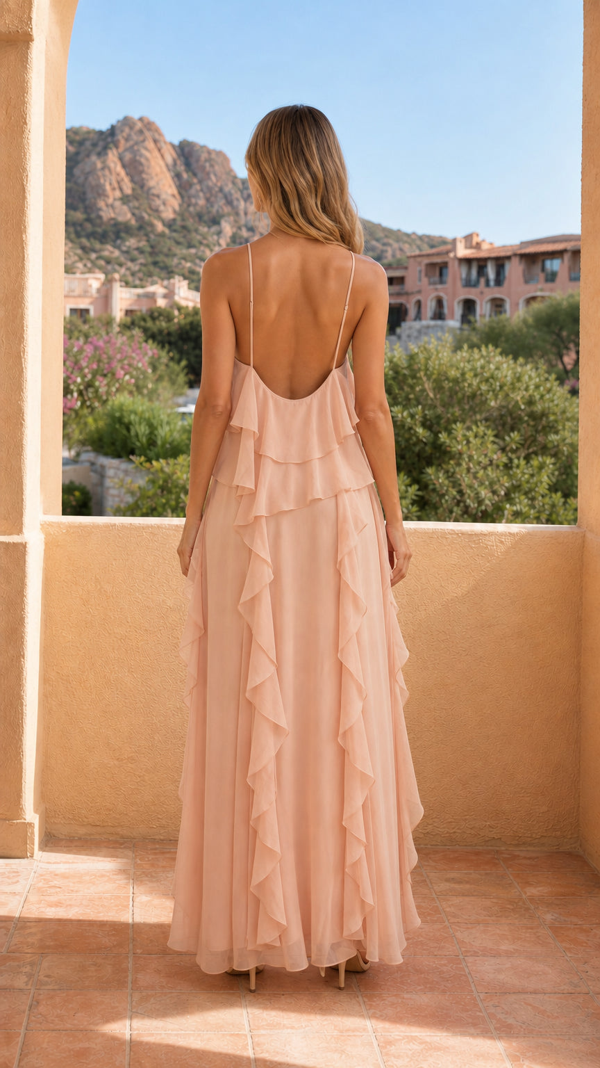 Back view of model in peach maxi dress showing open back straps