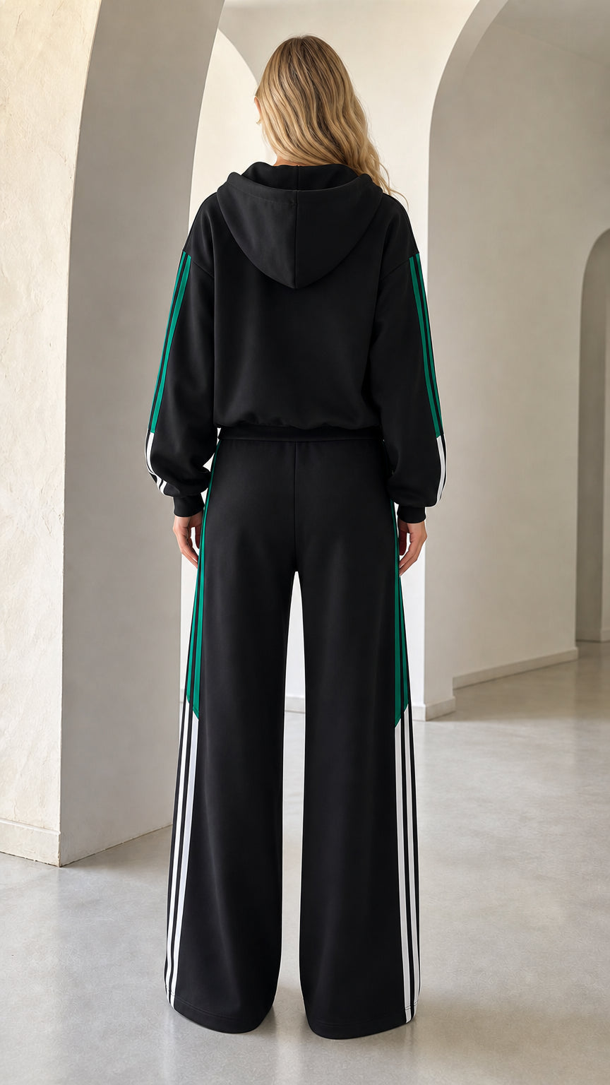 Back view of woman wearing hooded black tracksuit set with relaxed wide leg cut