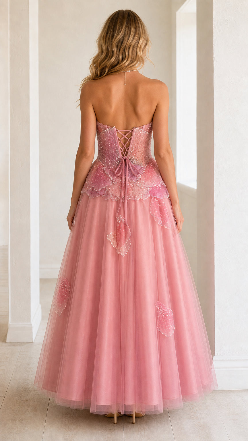 Back view of blush pink formal dress showcasing lace-up corset back detail