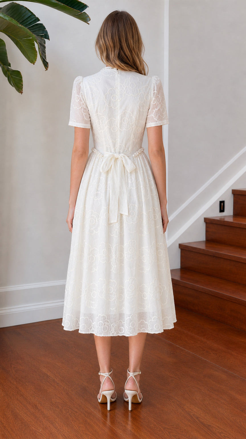 Back view of white floral midi dress showing tie sash waist and short sleeves