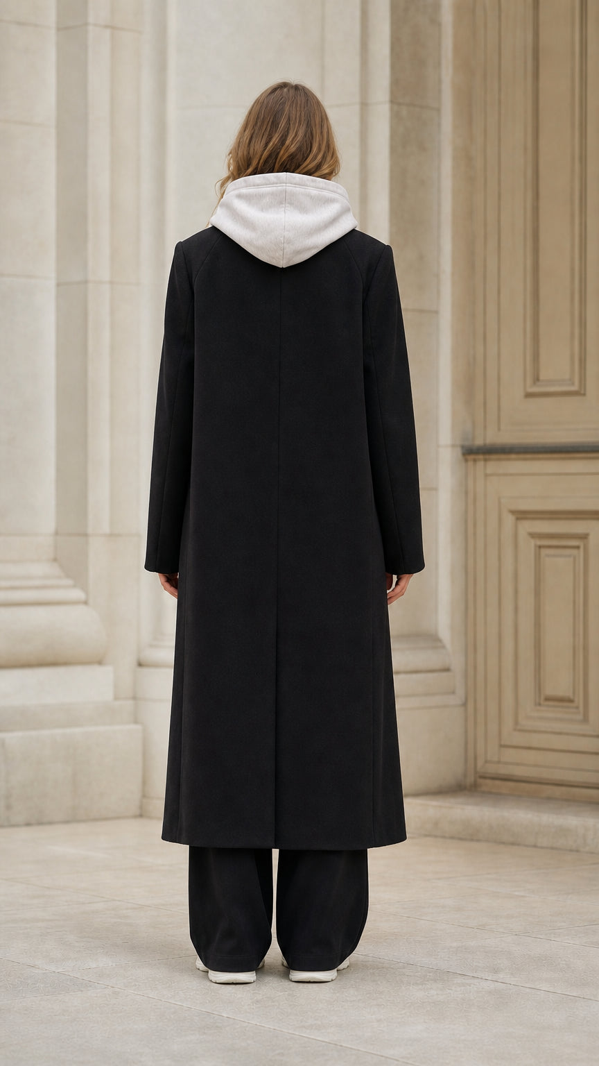 Back view of model wearing classic longline black overcoat