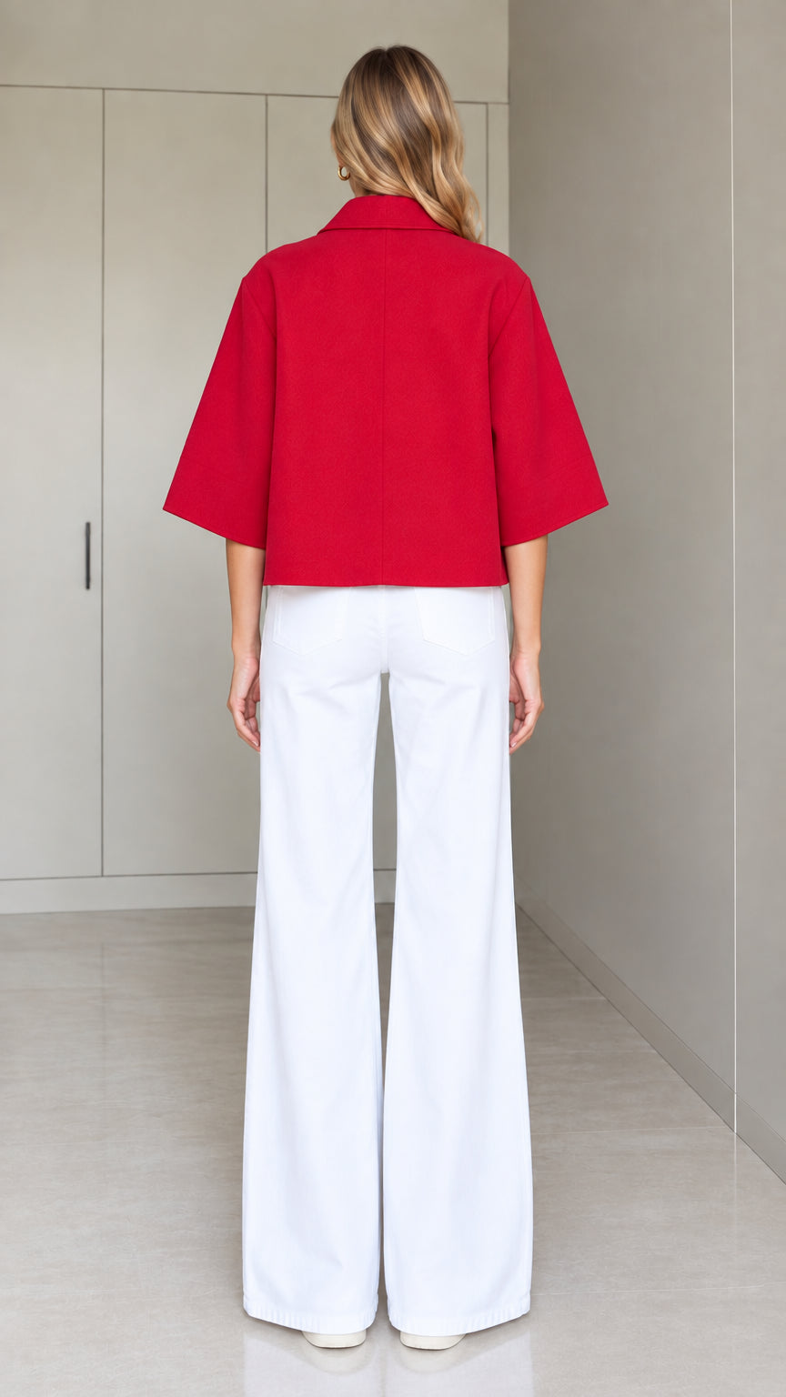 Back full-length view of a red cropped half-sleeve swing jacket showing relaxed silhouette