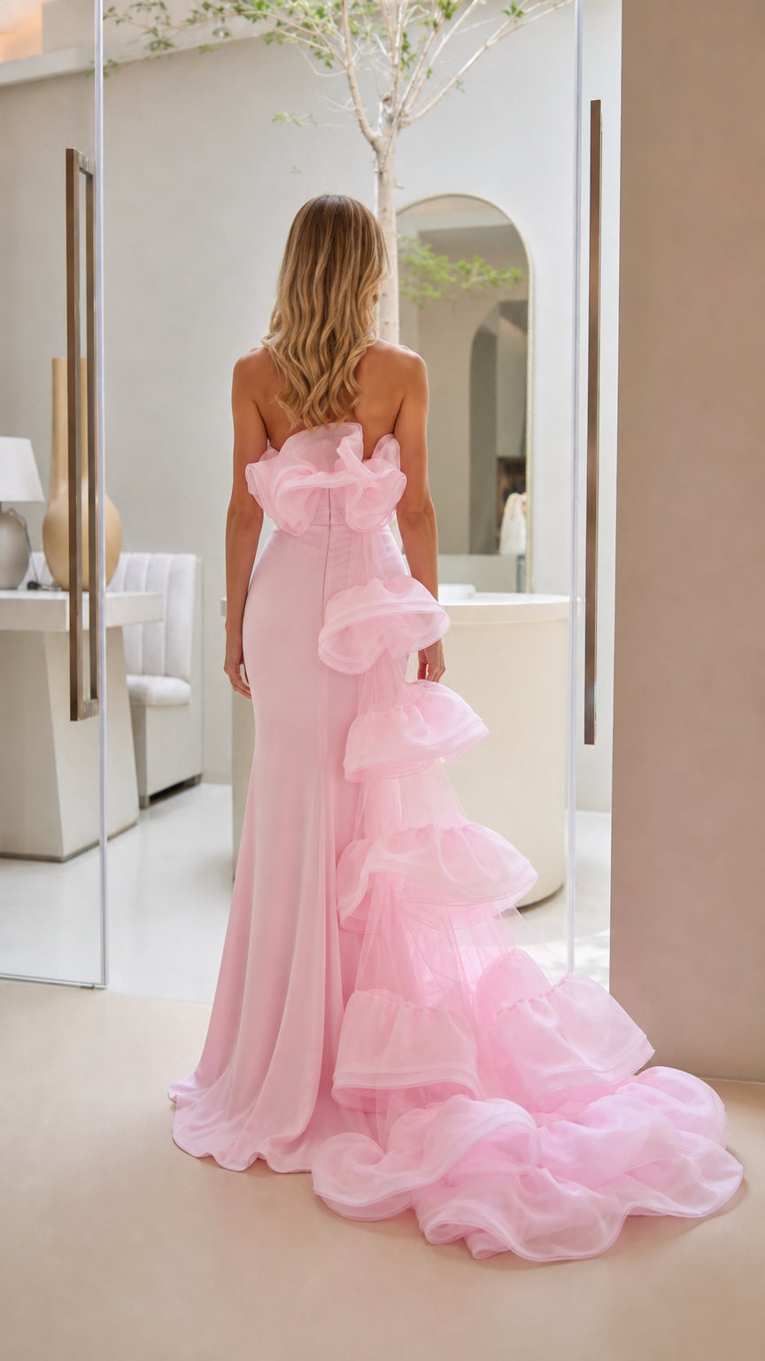 Back view of the evening gown highlighting cascading ruffle train