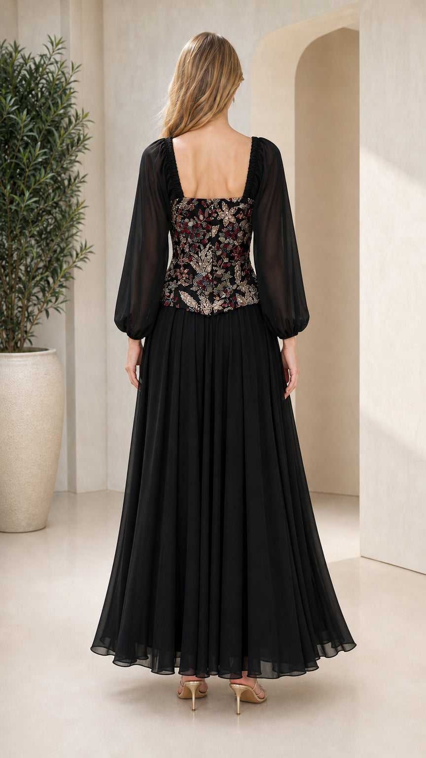 Back view of black long sleeve chiffon evening gown showing square neckline