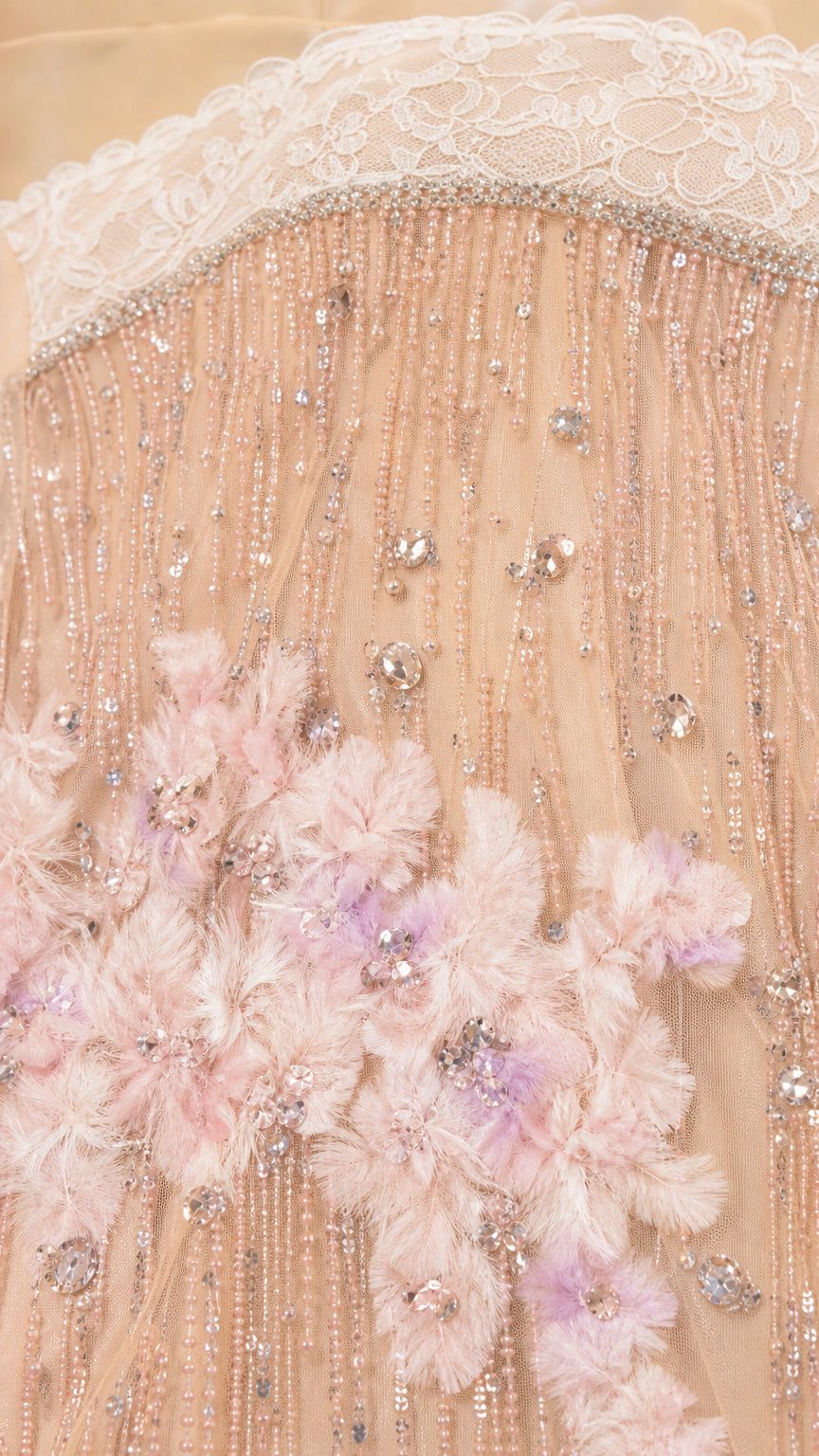 Close-up detail of bodice beadwork, sequins, and floral appliques