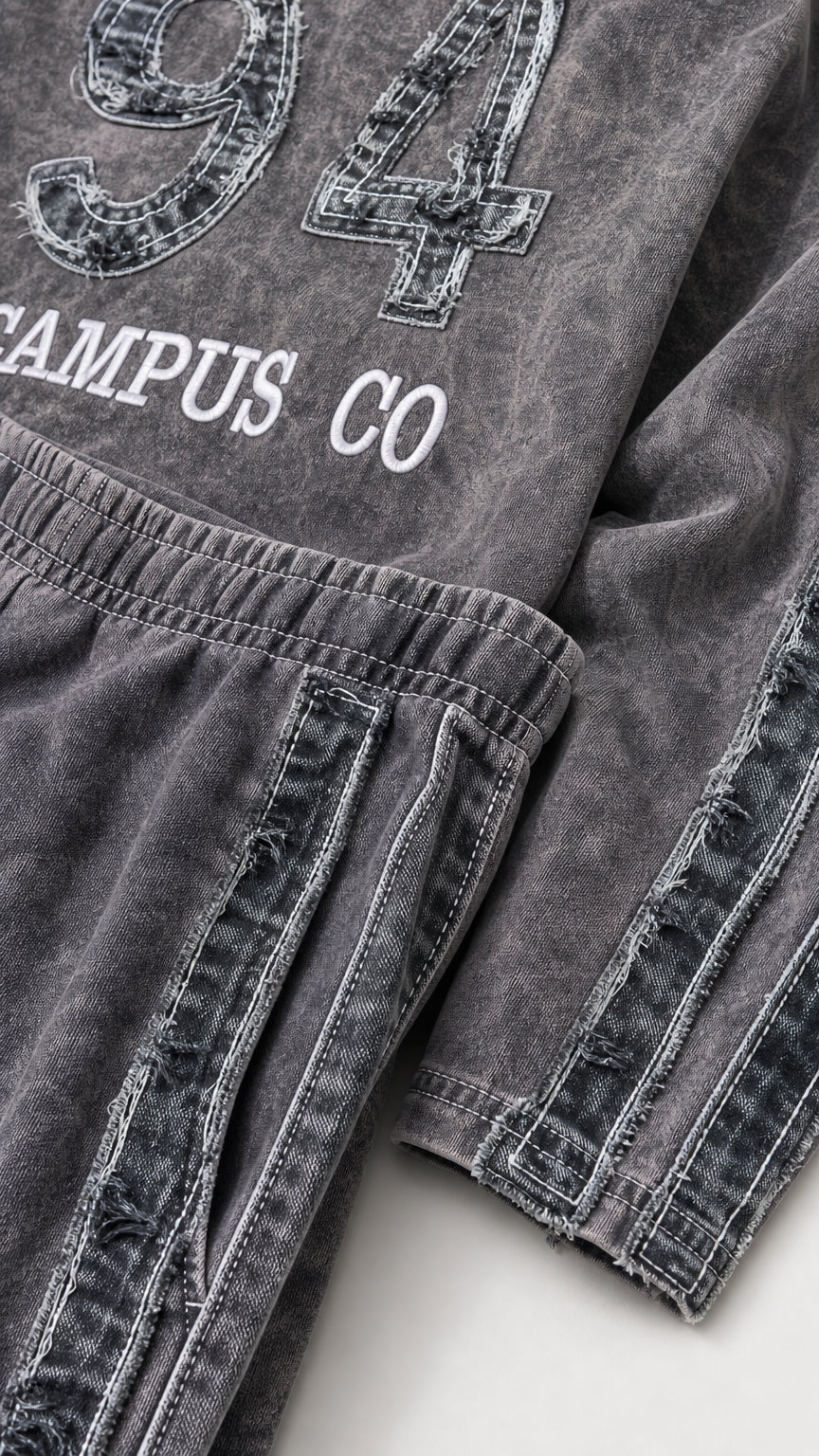 Close-up detail of '94 CAMPUS CO' lettering and distressed double side stripe trim on washed fabric