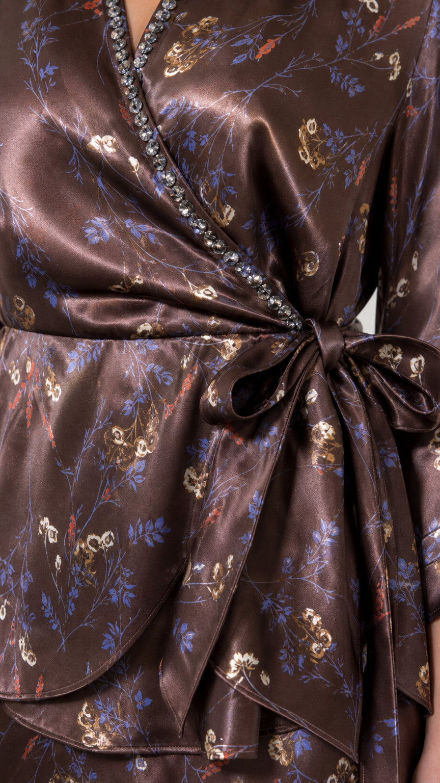 Close-up of rhinestone trim and wrap detail on brown blouse