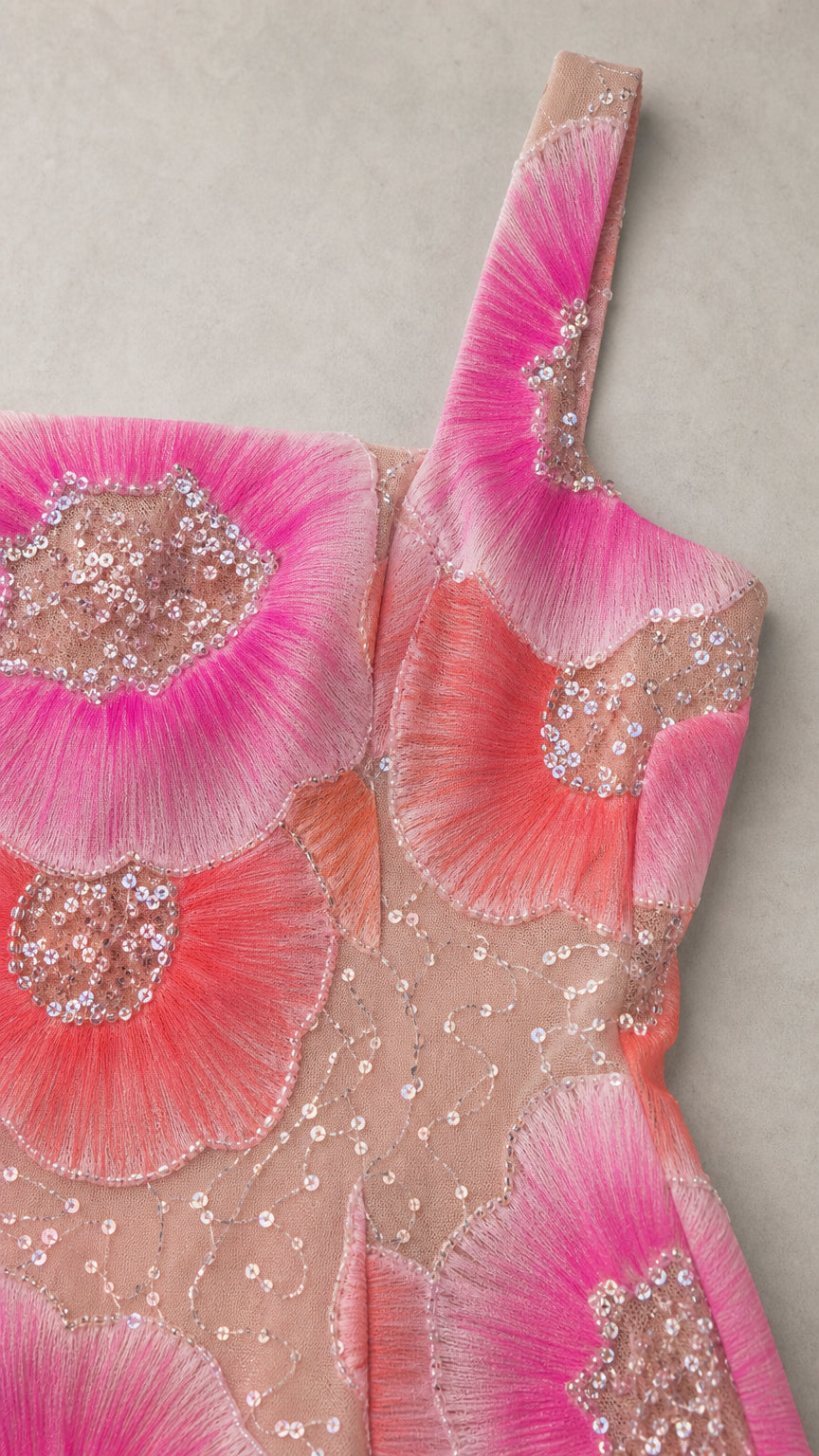 Close-up detail of intricate floral thread embroidery and sparkling sequins