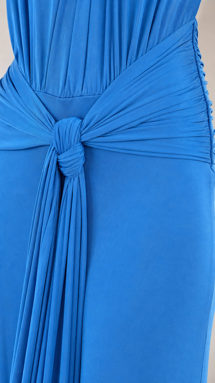 Close-up detail of front twisted knot and waist gathering on ocean blue dress