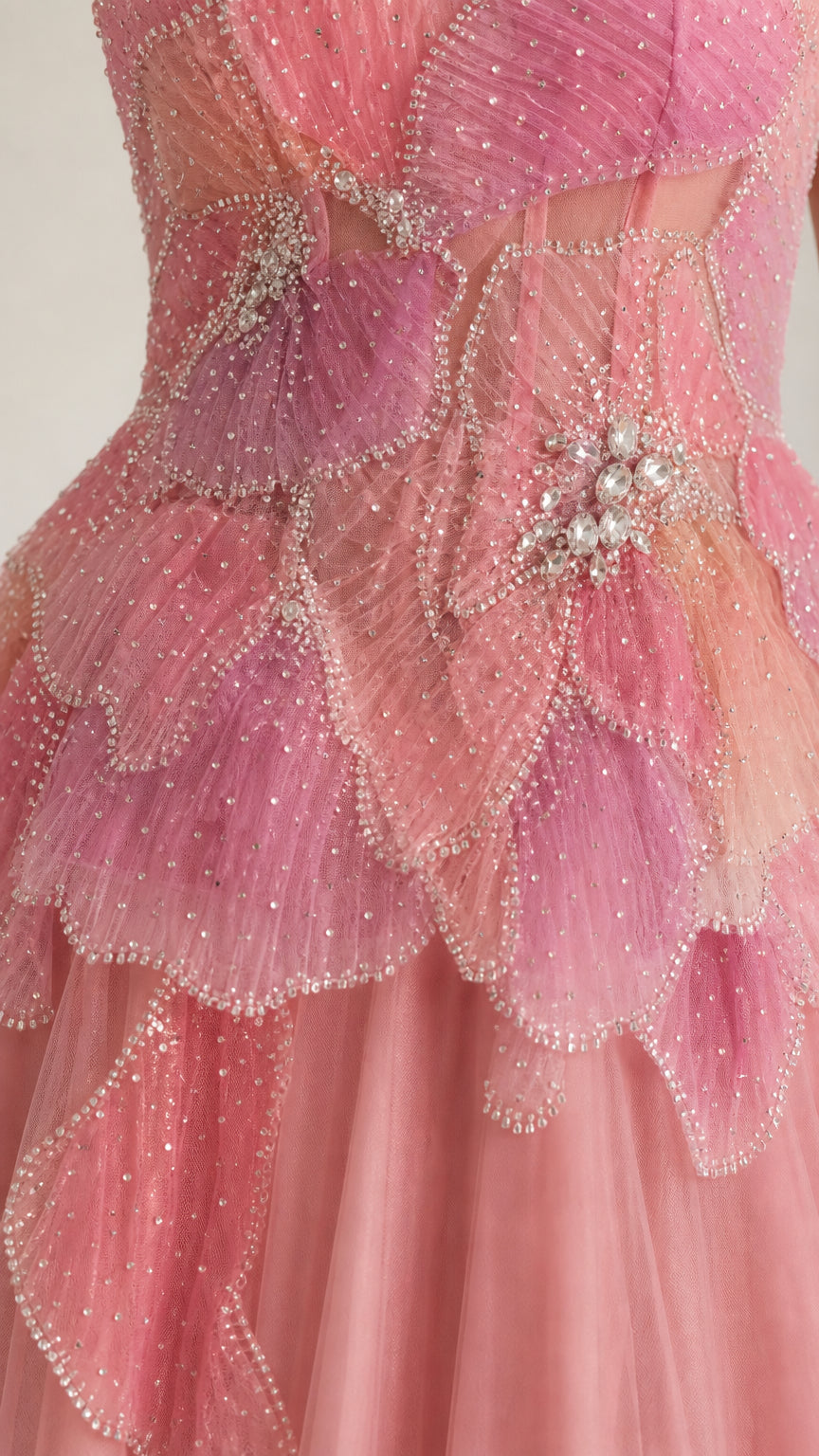 Close-up detail of blush pink beaded petal bodice with crystal embellishments