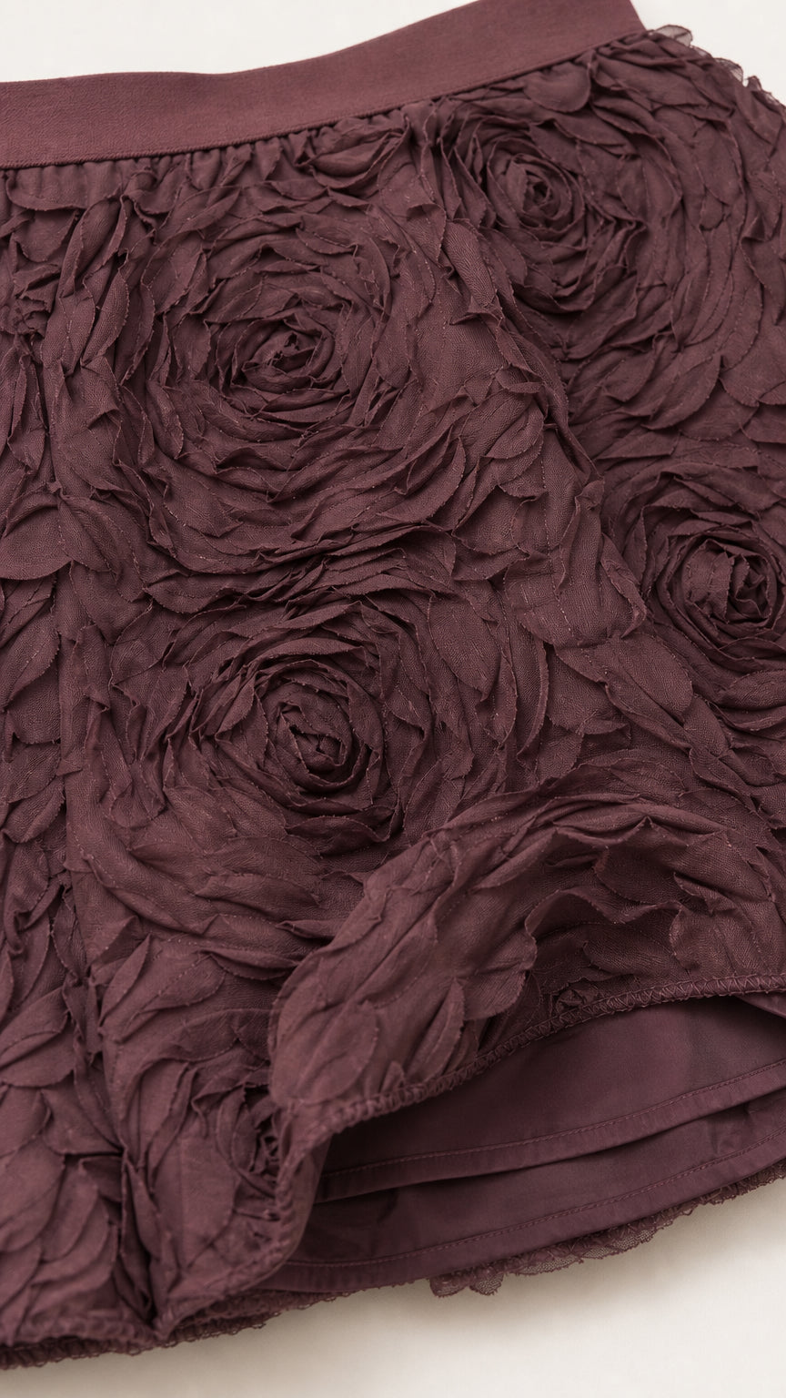 Close-up detail of the dimensional rose applique fabric and hemline