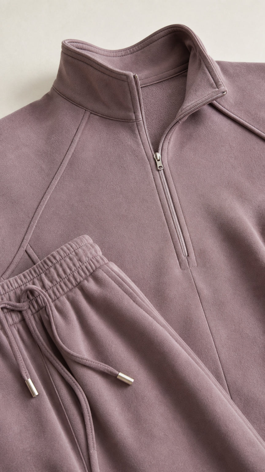 Close up view of dusty mauve half-zip neckline and drawstring waistband