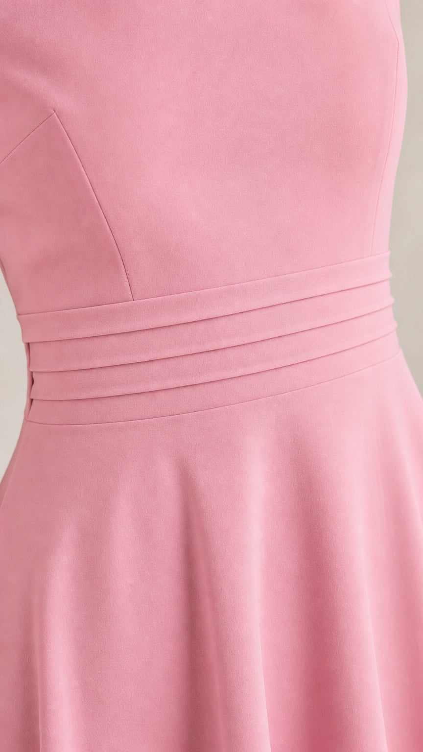 Close-up of pleated waist detail on pink dress